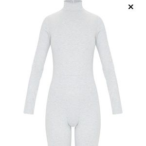 Grey jumpsuit with zippers on the end of the leg